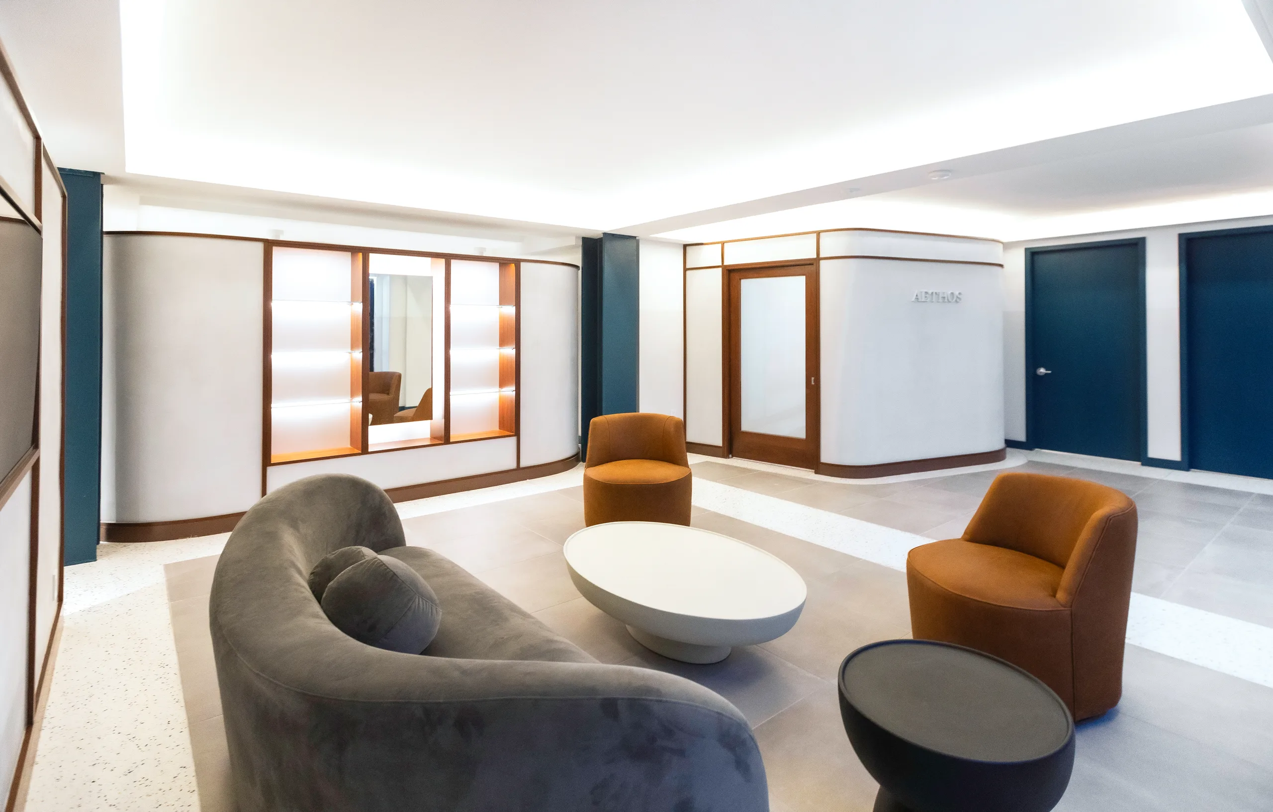 AETHOS finished lounge view with terrazzo flooring and walnut accents