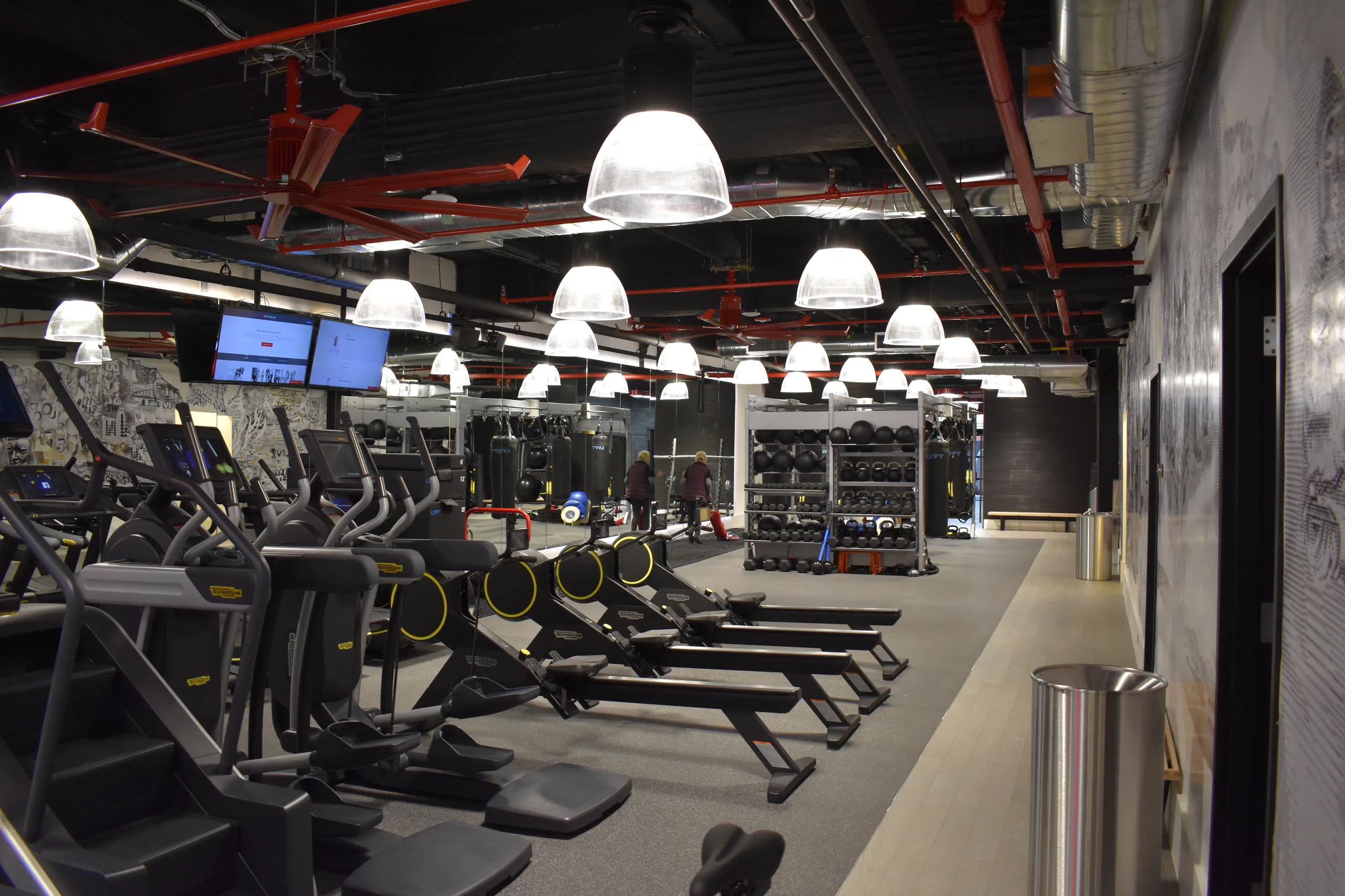 Goal Mine Health Club training floor with industrial lighting and cardio equipment