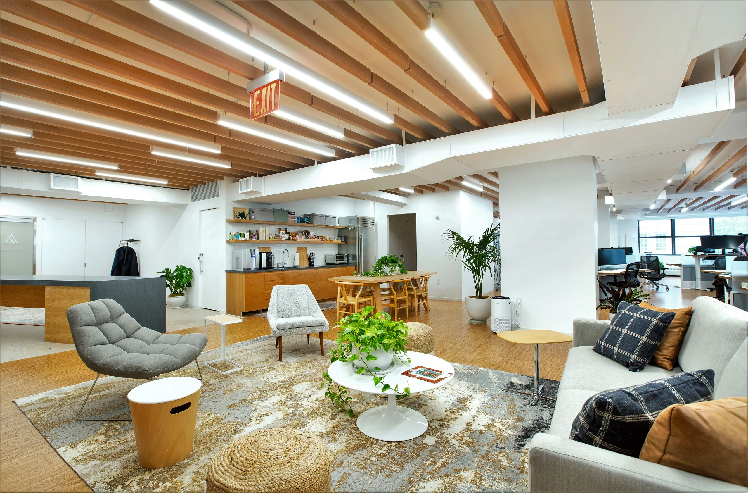 Greenland Capital hospitality-style collaboration area with oak finishes