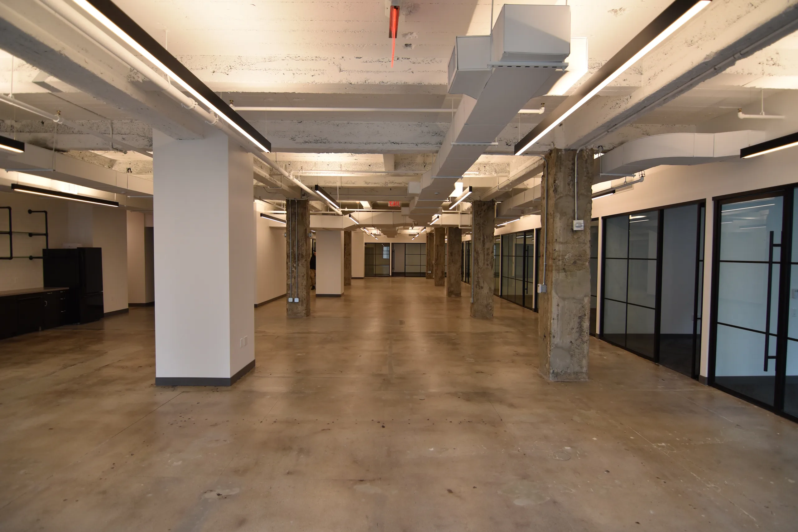2 Wall Street open office floor with exposed structure and linear lights