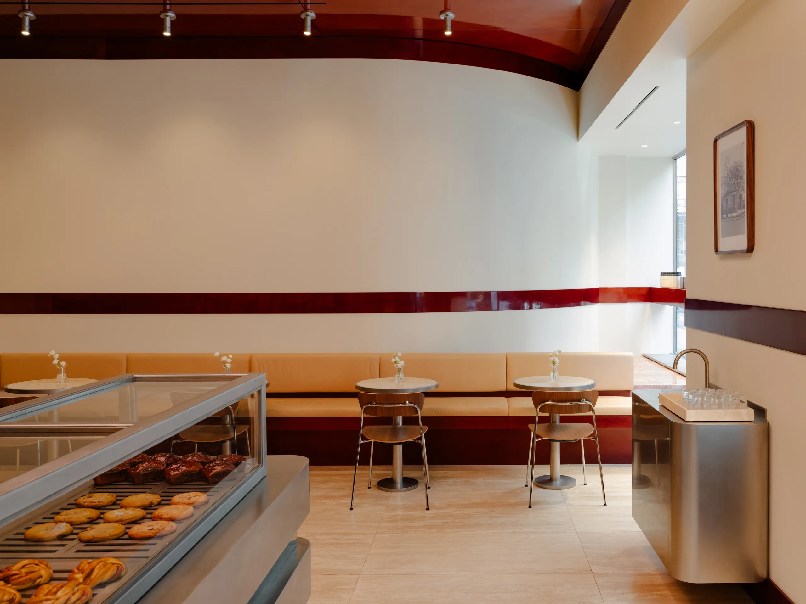 WatchHouse Chrysler seating area with deep red trim and pastry counter