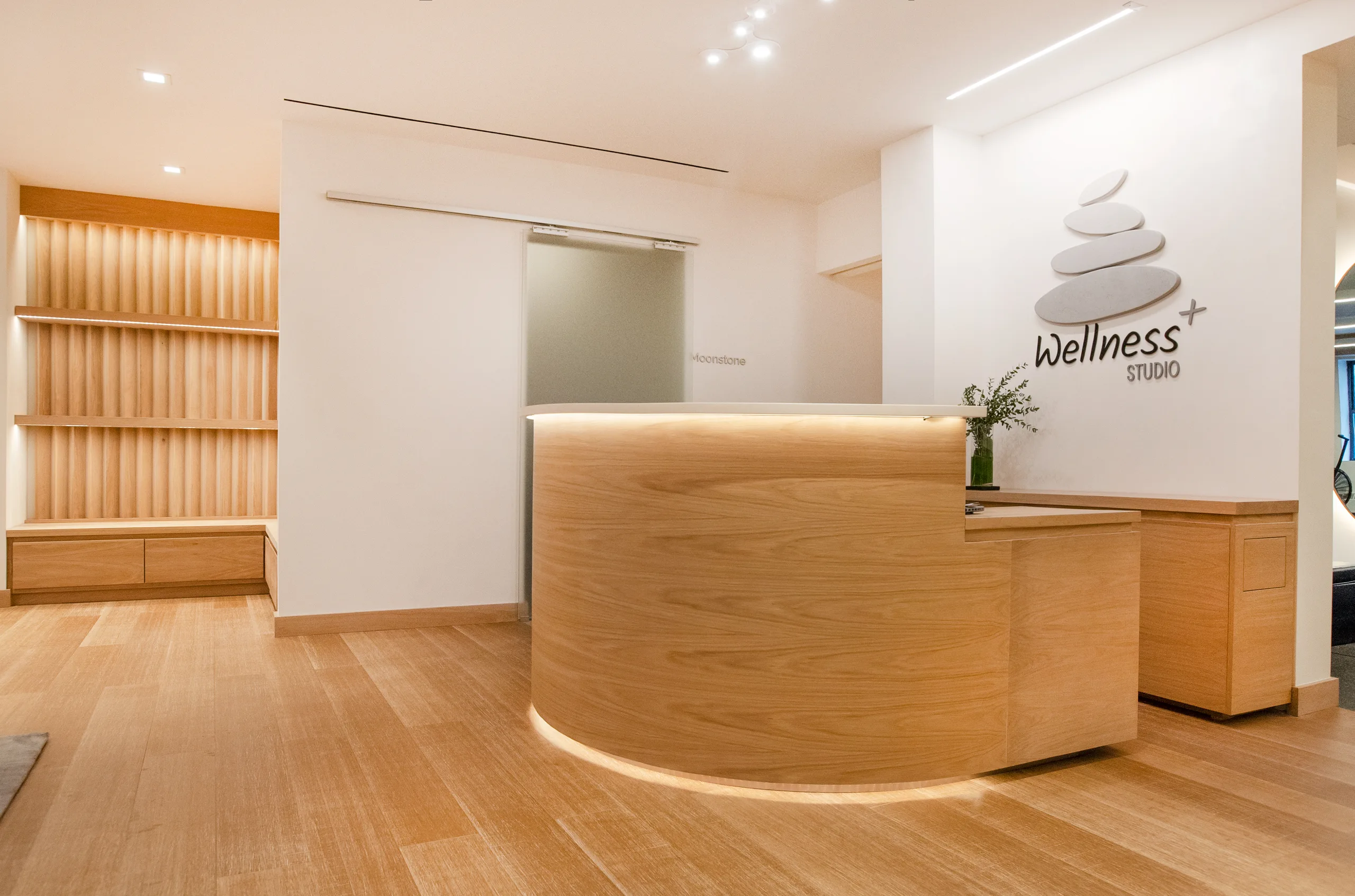 DRAX Wellness Center interior with pale wood finishes and softly lit treatment entry